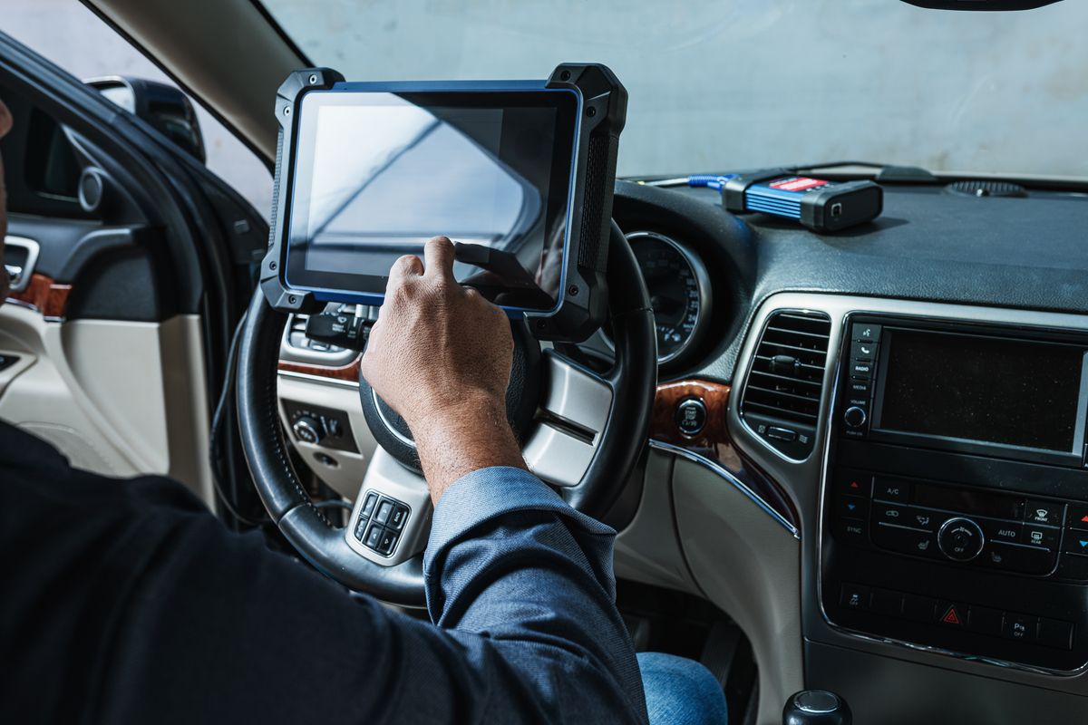 Technician performing OBD-II emissions test